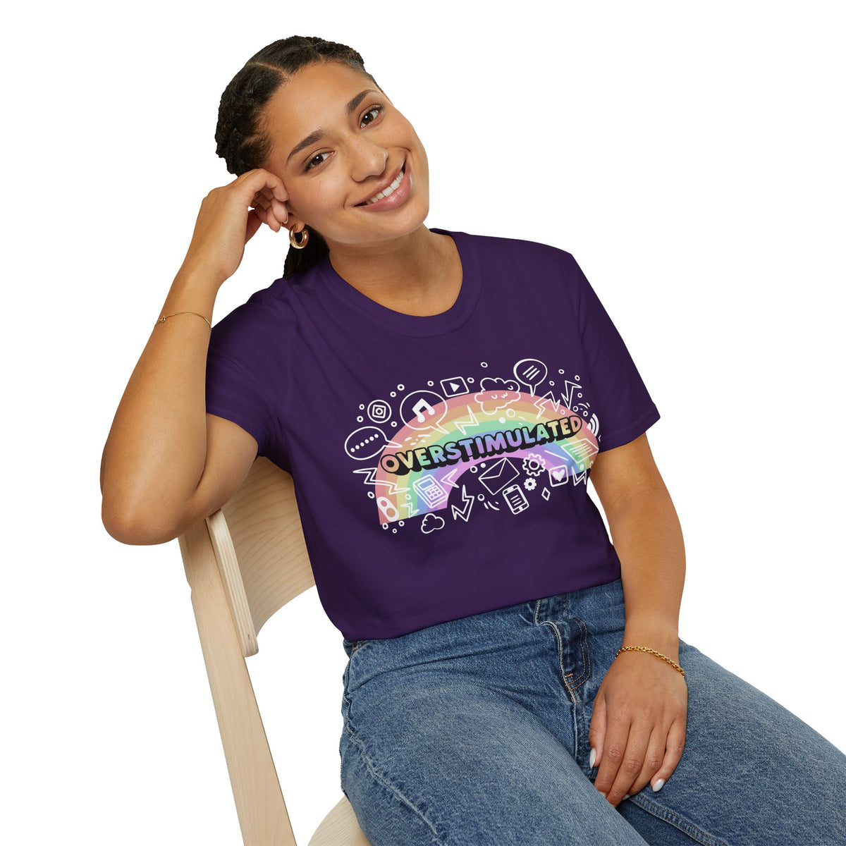Person wearing a purple t-shirt with a colorful graphic and text, sitting on a white background