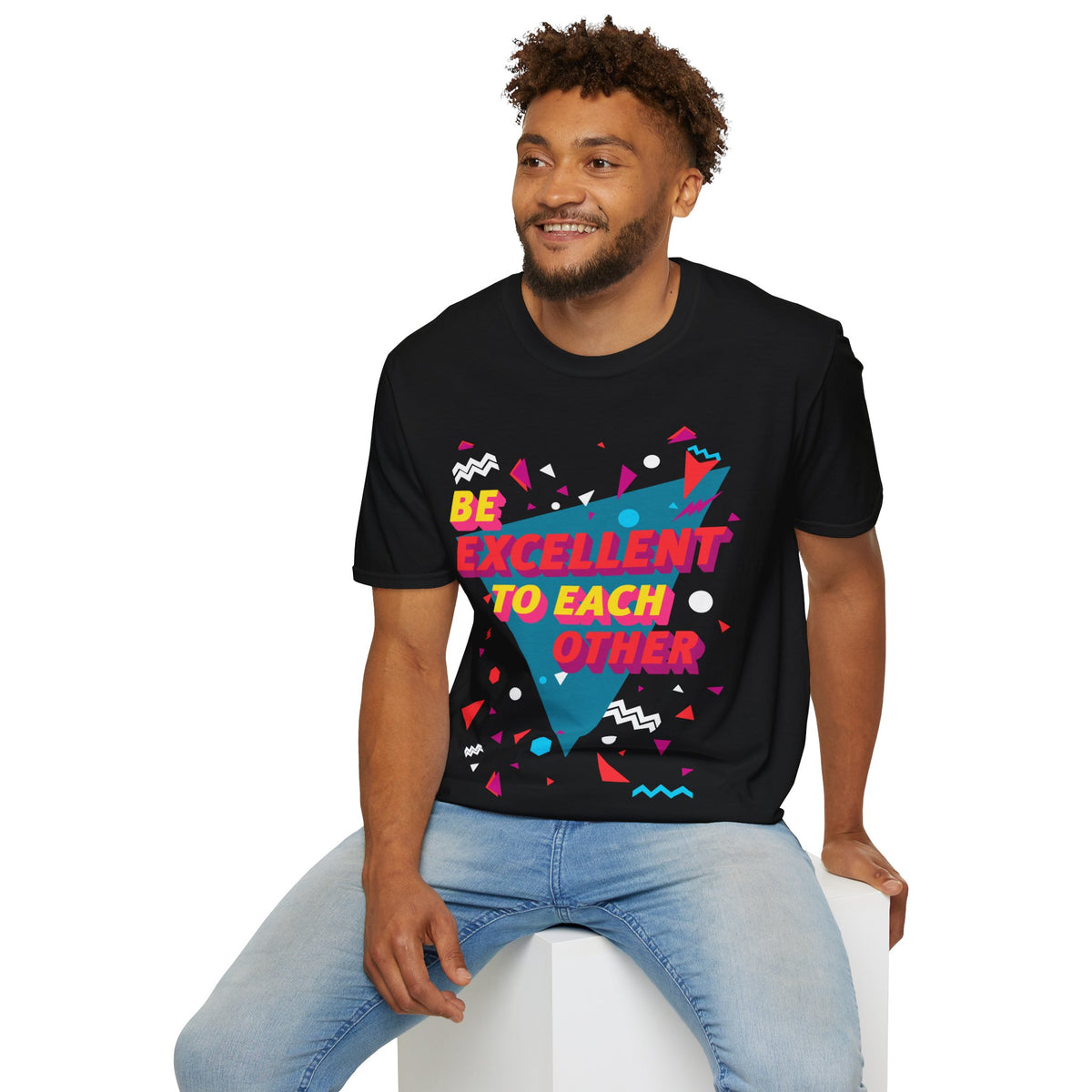 Man wearing a black t-shirt with colourful geometric design and Be Excellent to each other text