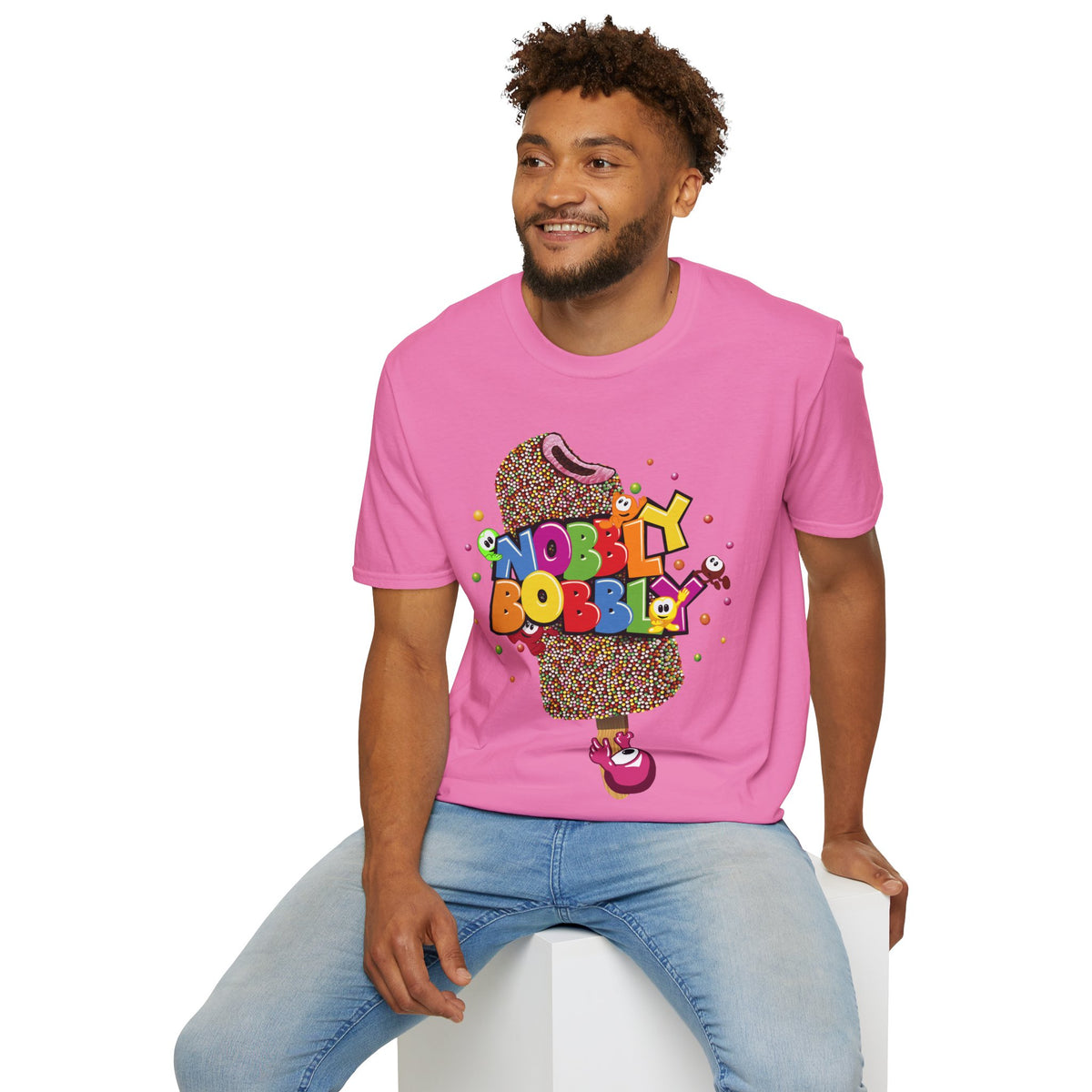 Man wearing a pink t-shirt with colorful graphic design on a white background