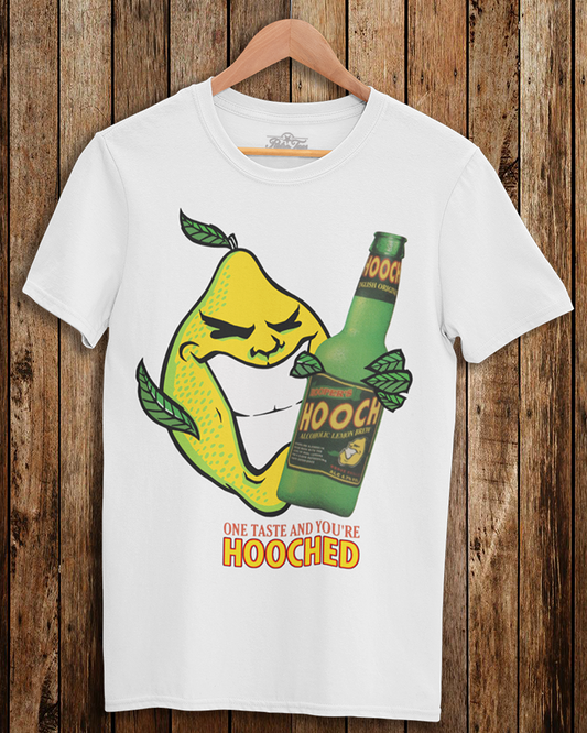 White t-shirt with a graphic design of a pear and bottle labeled 'Hooch' on a wooden background