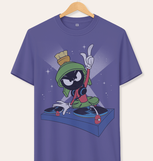 A short-sleeve crewneck t-shirt hanging on a wooden hanger against a light beige background. The shirt features a graphic print of the cartoon character Marvin the Martian DJing on turntables.