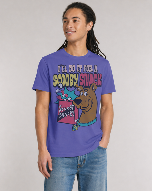 A man wearing a purple graphic t-shirt with a cartoon Scooby-Doo design and the text 'I'LL DO IT FOR A SCOOPY SNACK', paired with blue jeans, against a light gray studio background.