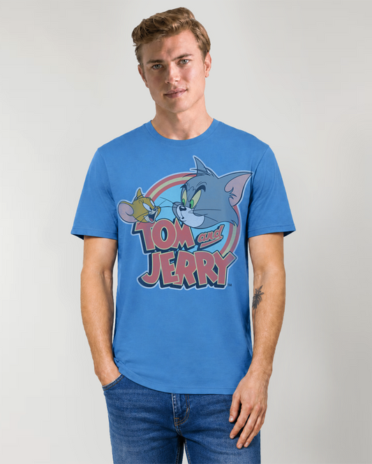 Man wearing a blue classic 'Tom and Jerry' logo t-shirt against a plain background