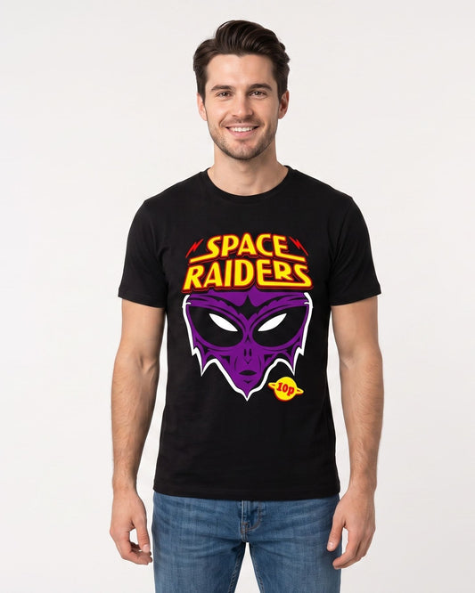 A man wearing a black crewneck t-shirt with a colorful 'Space Raiders' alien graphic on the front, paired with blue jeans, standing against a plain white studio background.