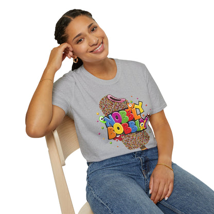 Person wearing a gray t-shirt with colorful 'Nobbly Bobbly' design, sitting on a chair.
