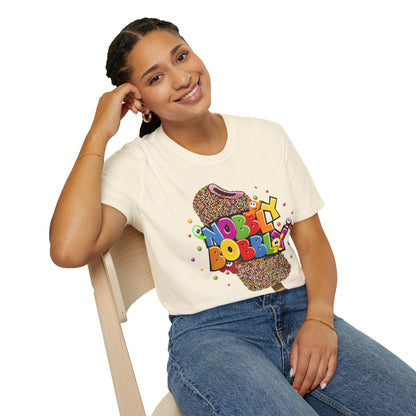 Person wearing a white t-shirt with colorful text and graphics, sitting on a chair.