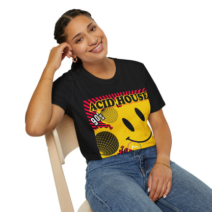 Person wearing a black t-shirt with colourful 90s acid house rave graphics and text, sitting on a chair.