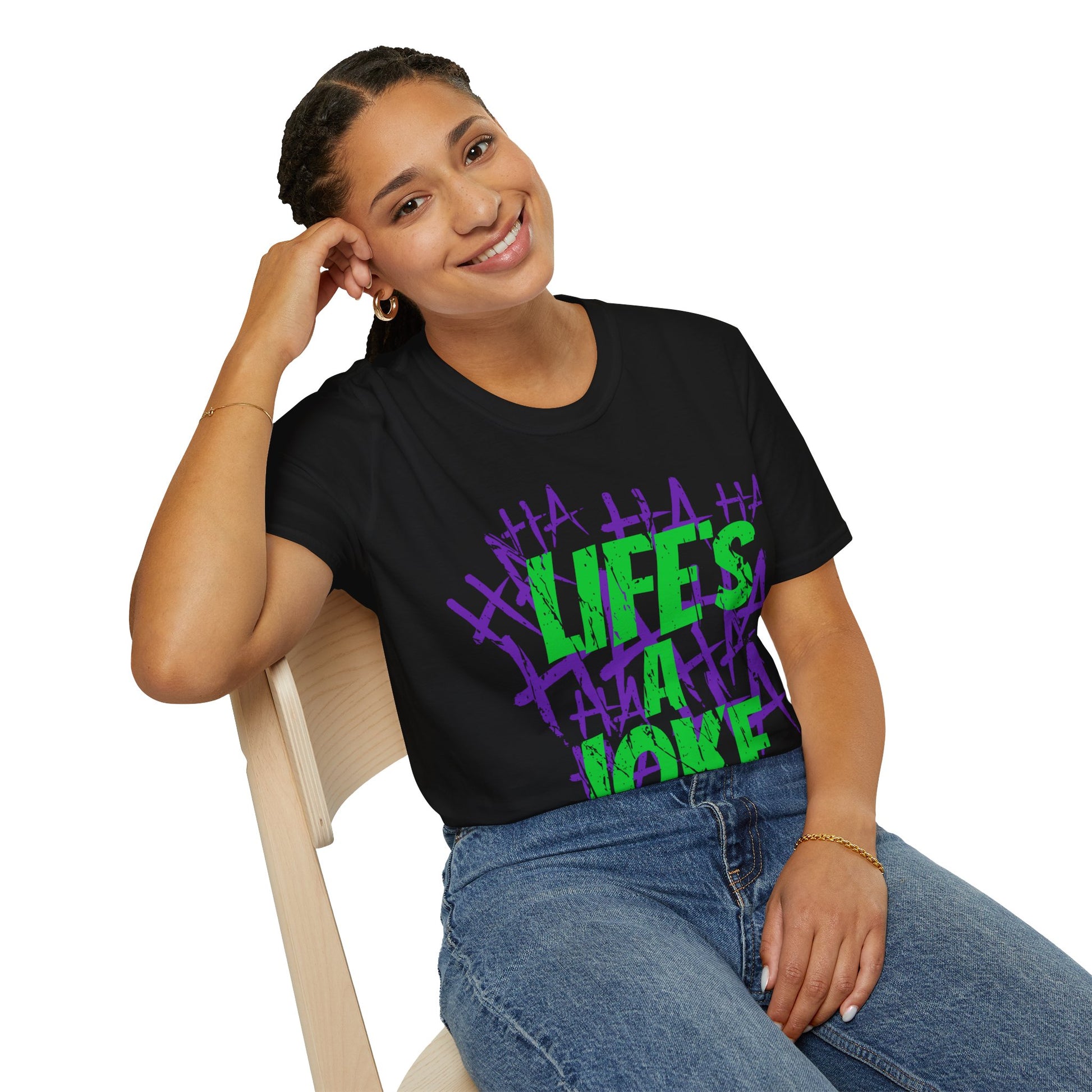 Person wearing a black t-shirt with colourful text design Green, Life's A Joke with purple HA HA HA HA on a white background