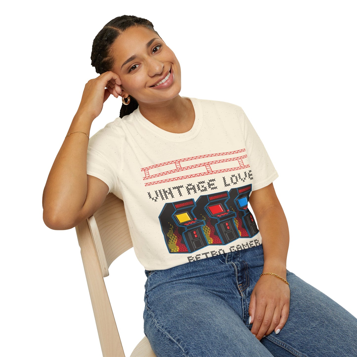 Woman wearing a 'Vintage Love Retro Gamer' t-shirt sitting on a chair.