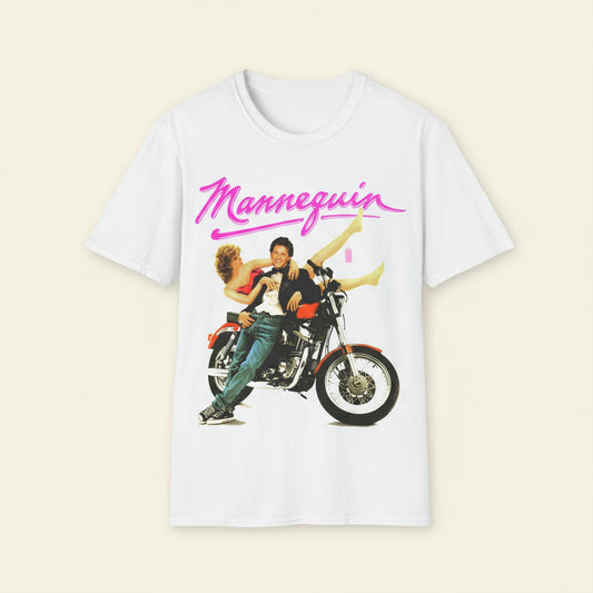 White t-shirt with graphic of two people on a motorcycle and 'Mannequin' text in pink.