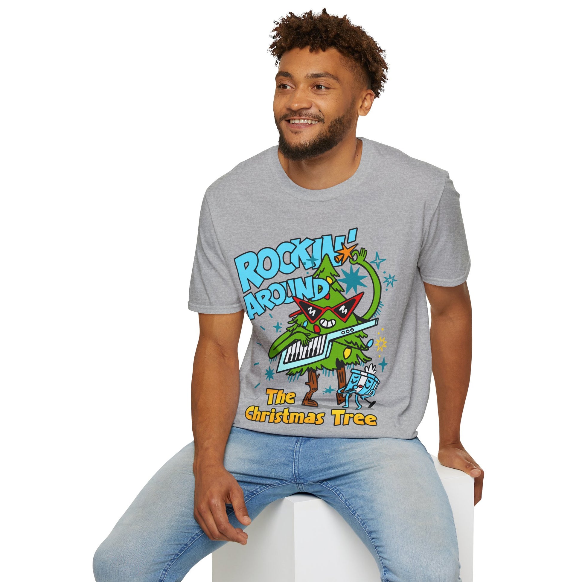 Person wearing a Retro christmas Music Inspired grey t-shirt with a colourful graphic of a Christmas tree and text Rockin Around The Christmas Tree 