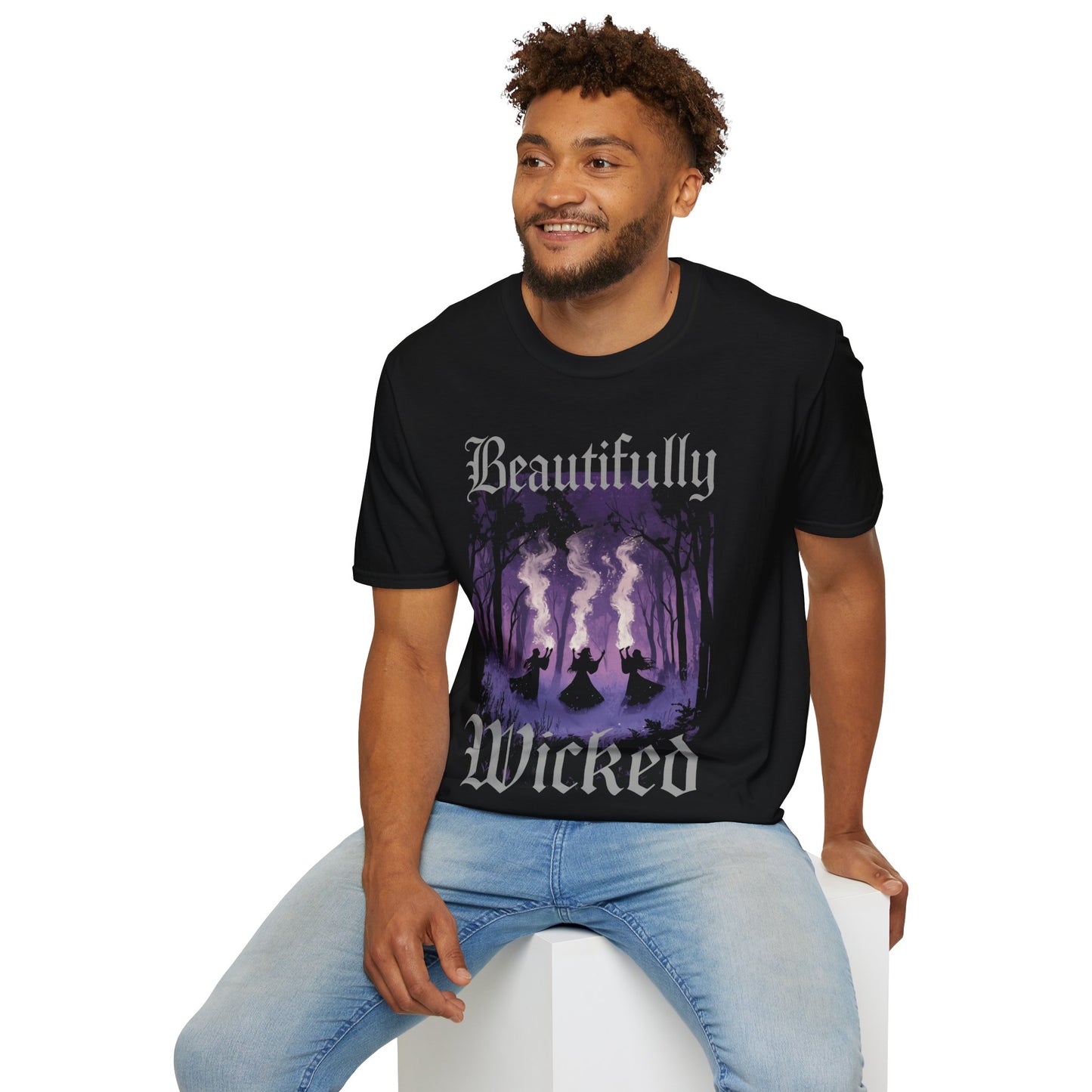 Man wearing a black t-shirt with 'Beautifully Wicked' Agatha All Along inspired graphic design on a white background