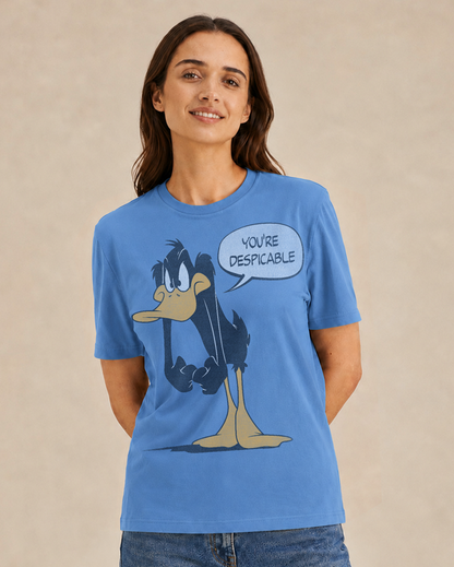 Woman wearing a blue t-shirt with a cartoon character and text on a beige background