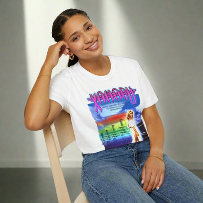 Person wearing a white t-shirt with a colourful graphic design featuring  'Xanadu' retro movie poster print.