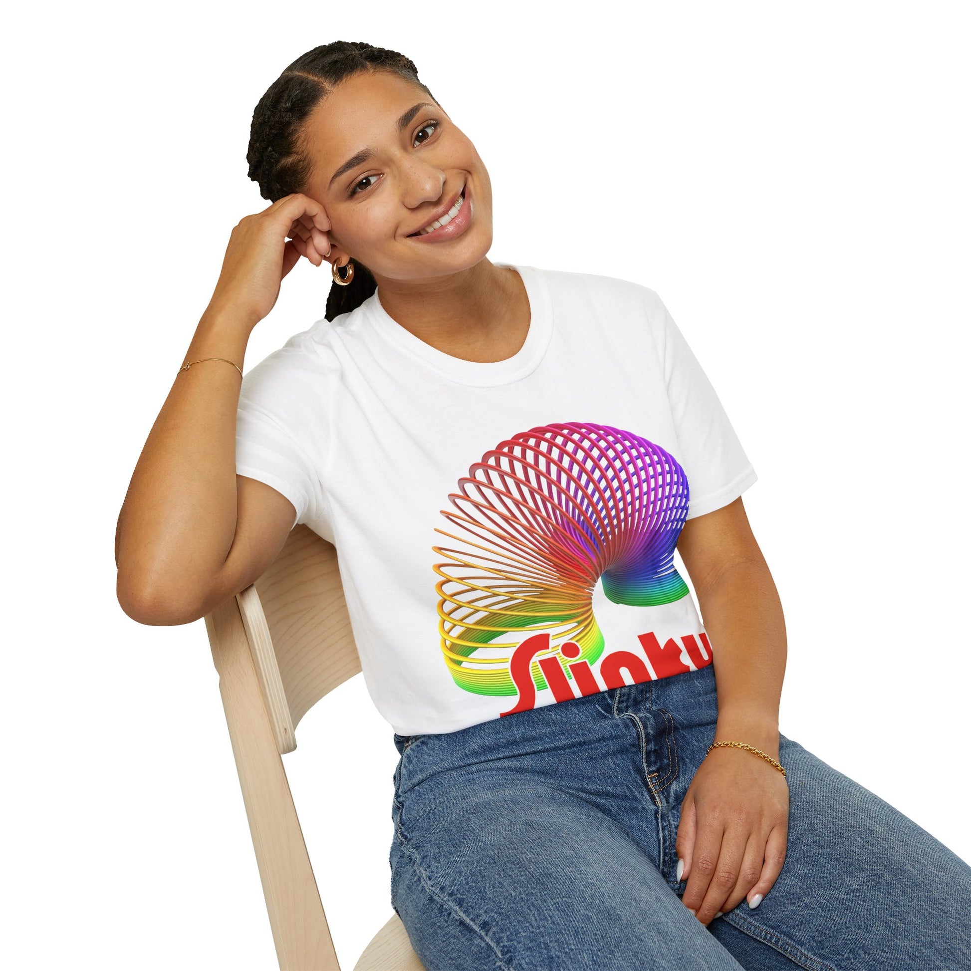 Person wearing a white t-shirt with a colorful Slinky logo sitting on a chair.