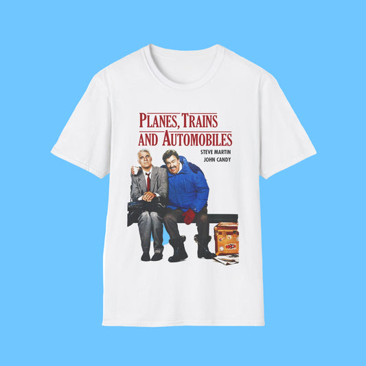 White t-shirt with a graphic of two men sitting on a bench and text 'Planes, Trains and Automobiles' on a white background.
