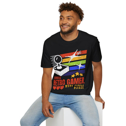Man wearing a black t-shirt with a colorful graphic and text, sitting on a white stool against a white background.