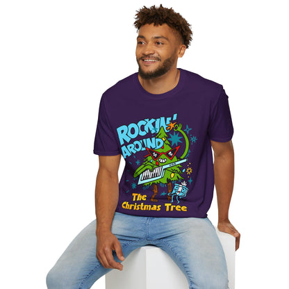 Person wearing a Retro christmas Music Inspired purple t-shirt with a colourful graphic of a Christmas tree and text Rockin Around The Christmas Tree 