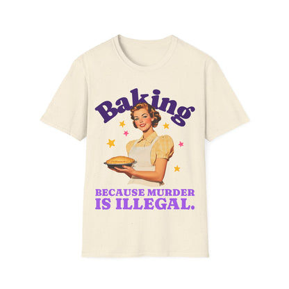 Beige t-shirt with a graphic of a woman holding a pie and text 'Baking Because Murder is Illegal' on a white background.