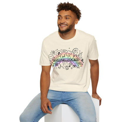 Man wearing a cream t-shirt with colorful graphics and text sitting on a white stool against a white background