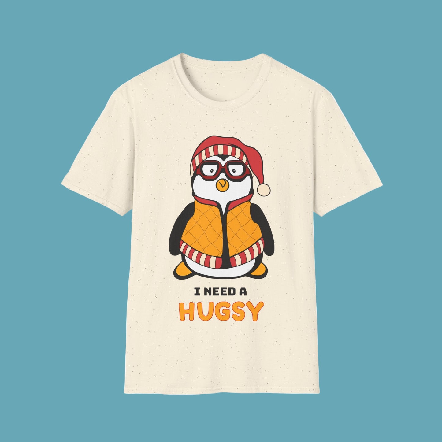 Beige t-shirt with a penguin graphic and I Need A Hugsy text
