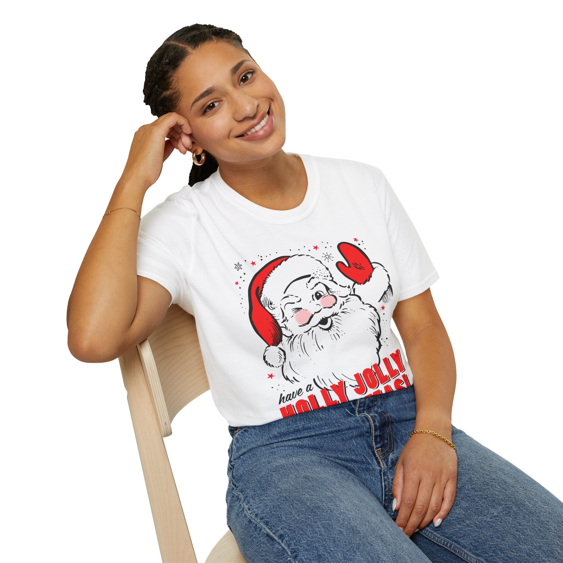 Person wearing a white t-shirt with a Santa Claus graphic and text, sitting on a chair.