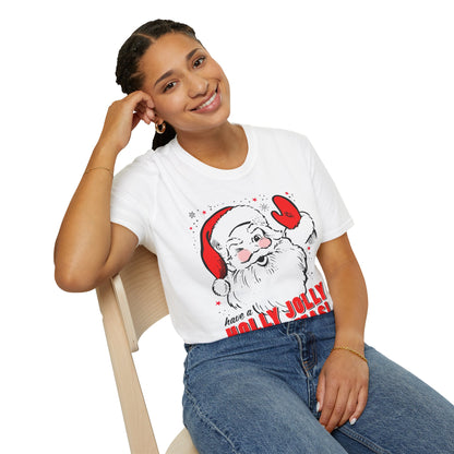 Person wearing a white t-shirt with a Santa Claus graphic and text, sitting on a chair.