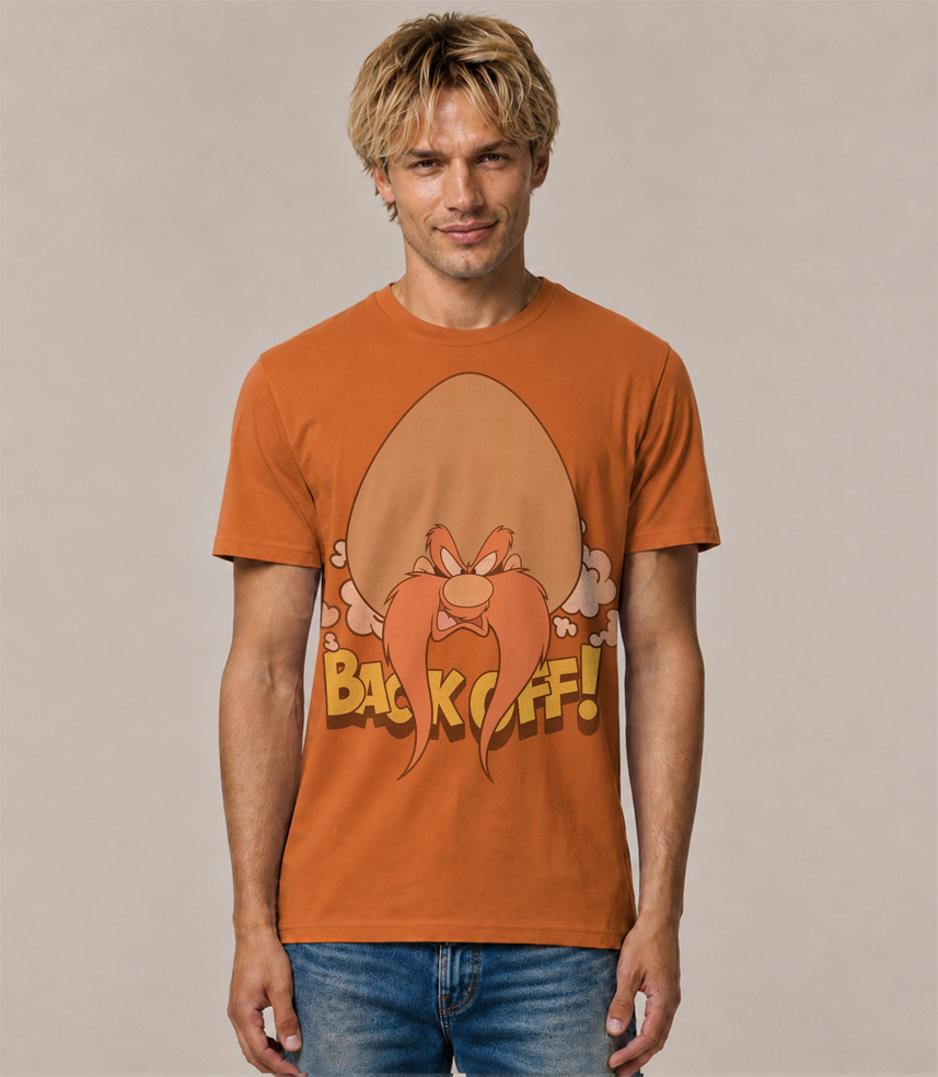 Man wearing a Cinnamon coloured short sleeve  t-shirt with Yosemite Sam graphic design with Back OFF text on a beige background