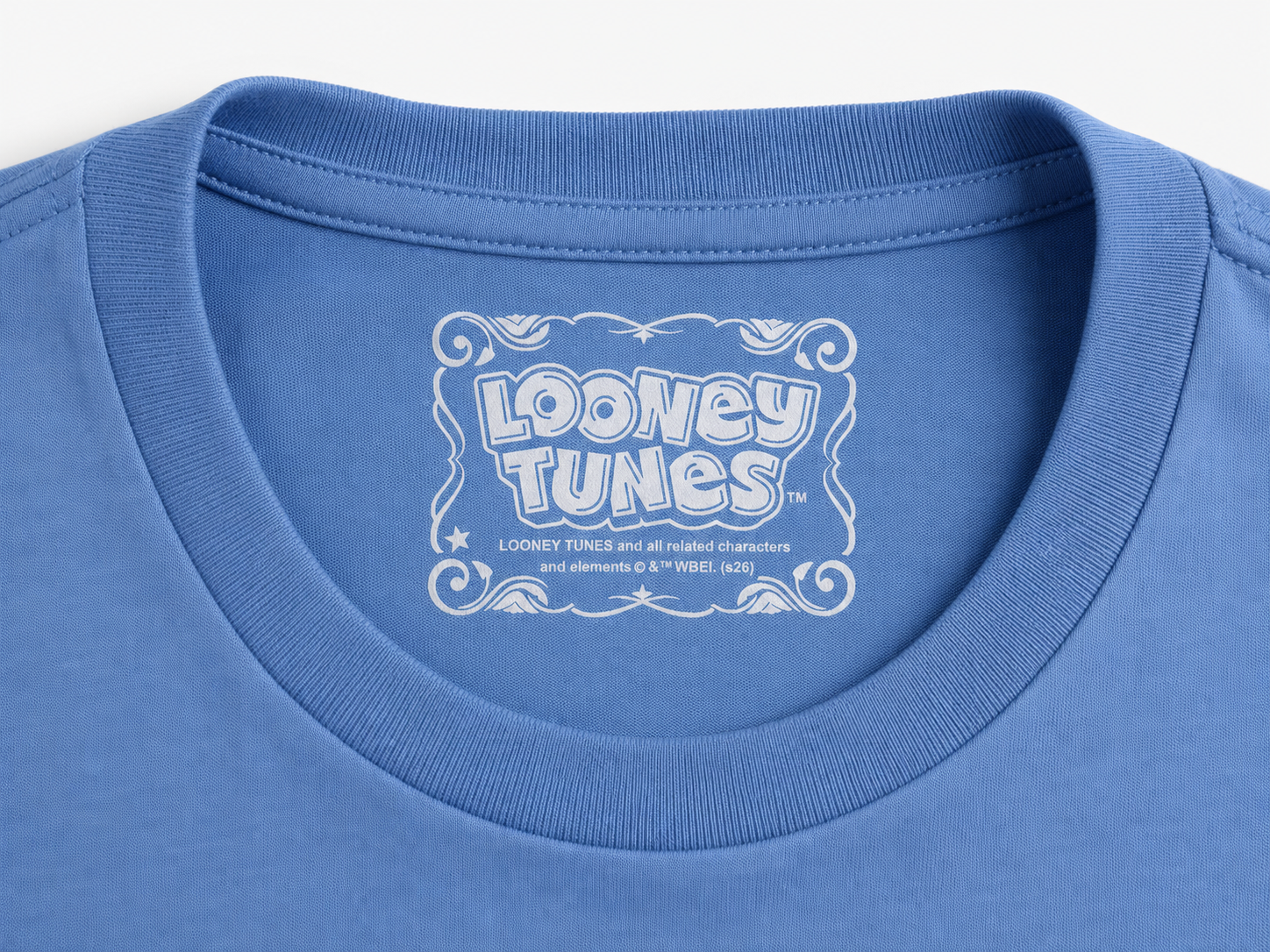 Close-up of a blue crewneck t-shirt showing the inner neck label with a white Looney Tunes logo.