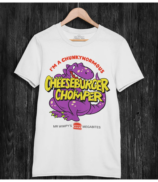 White t-shirt with a purple dinosaur graphic and I'm A Chunkynormous Cheeseburger Chomper text on a wooden hanger against a dark wooden background