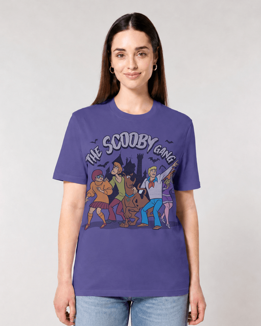 A woman modelling a dusk blue short-sleeve graphic t-shirt featuring 'The Scooby Doo Gang' characters in a spooky Halloween-themed illustration.