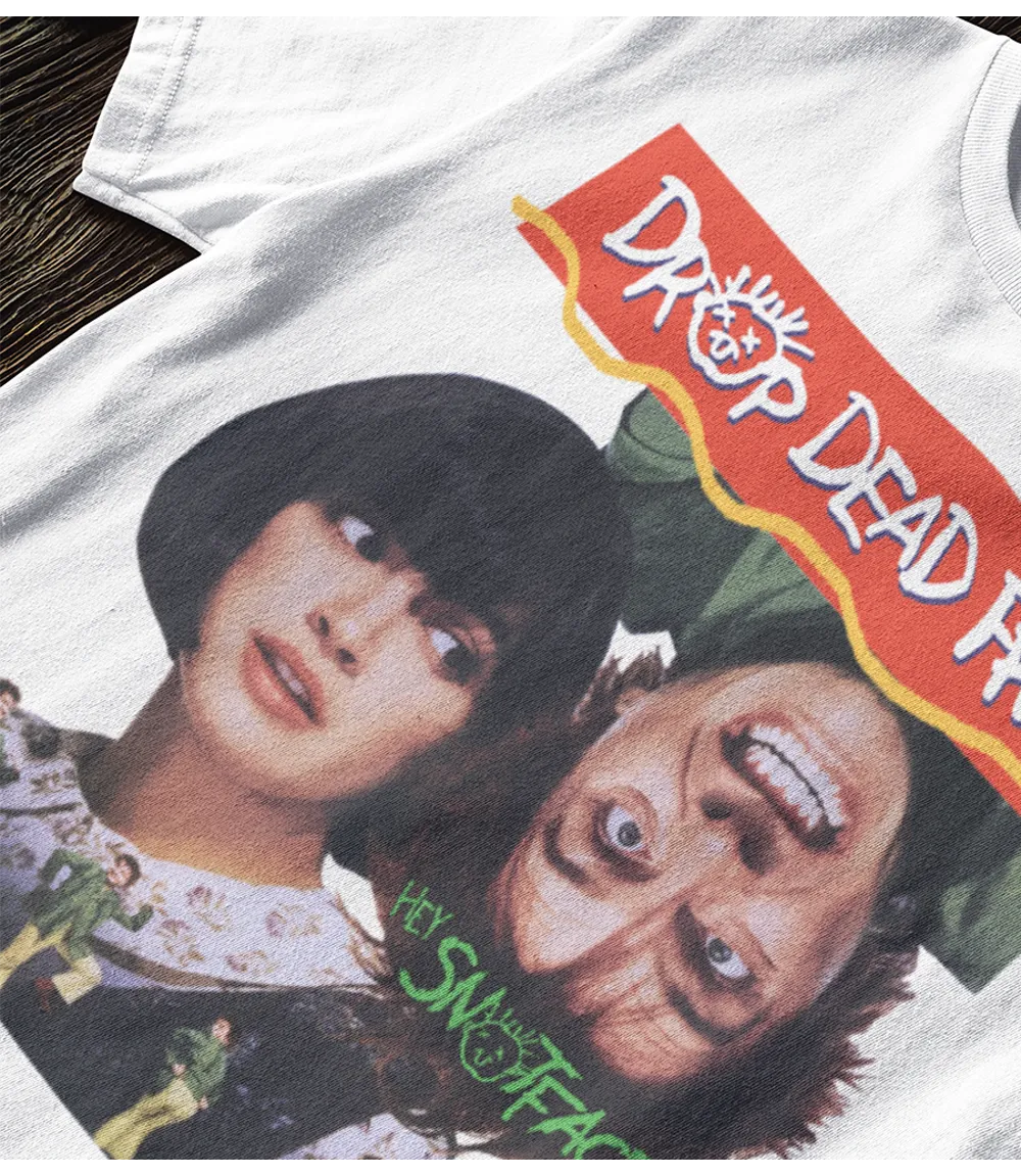 Retro Tees 90s Movie poster Drop Dead Fred unisex T-shirt. White short sleeve crew neck graphic movie design top laying in a Christmas display