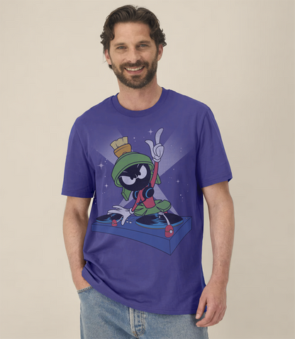 Man wearing a dusk blue short sleeve  t-shirt with graphic of Marvin The Martian  cartoon Looney Tune character  being a DJ on a beige background
