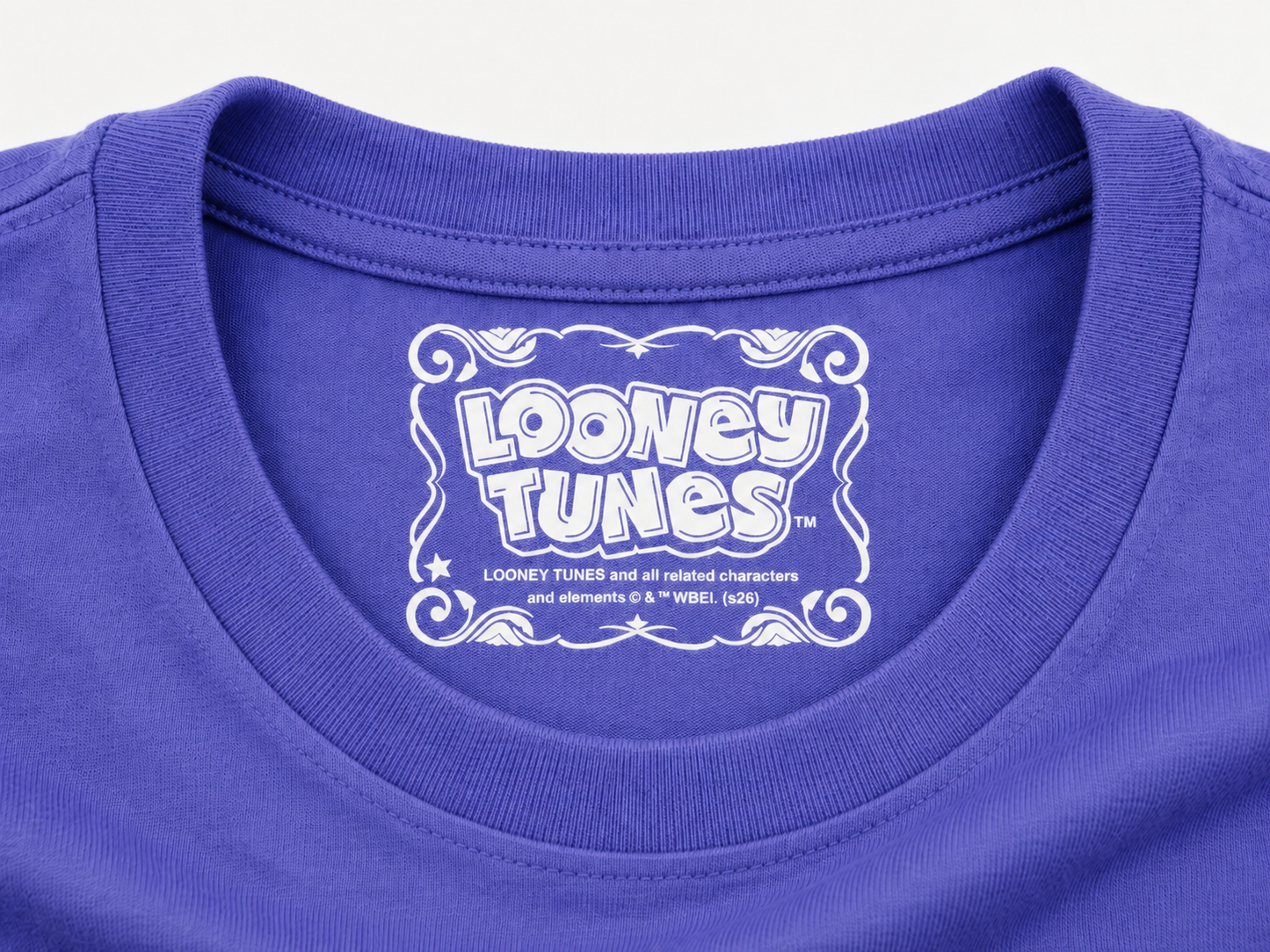 Close-up of a dusk blue crewneck t-shirt featuring a white Looney Tunes graphic printed inside the collar.