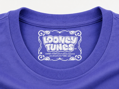 Close-up of a dusk blue crewneck t-shirt featuring a white Looney Tunes graphic printed inside the collar.