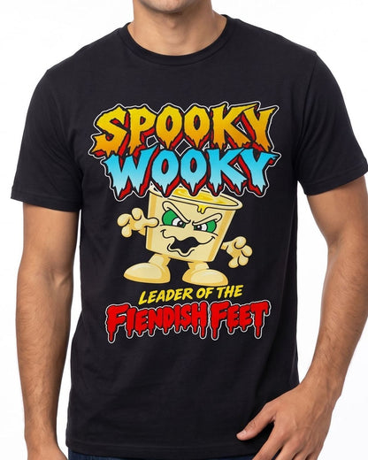 A man wearing a black short-sleeve t-shirt with a colorful graphic print that reads 'Spooky Wooky Leader of the Fiendish Feet' with a cartoon character.