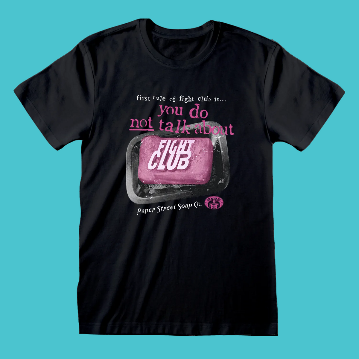 A black short-sleeve crewneck t-shirt featuring a graphic print on the front. The graphic shows a pink bar of soap labeled 'FIGHT CLUB' inside a soap dish, with the text 'first rule of fight club is.