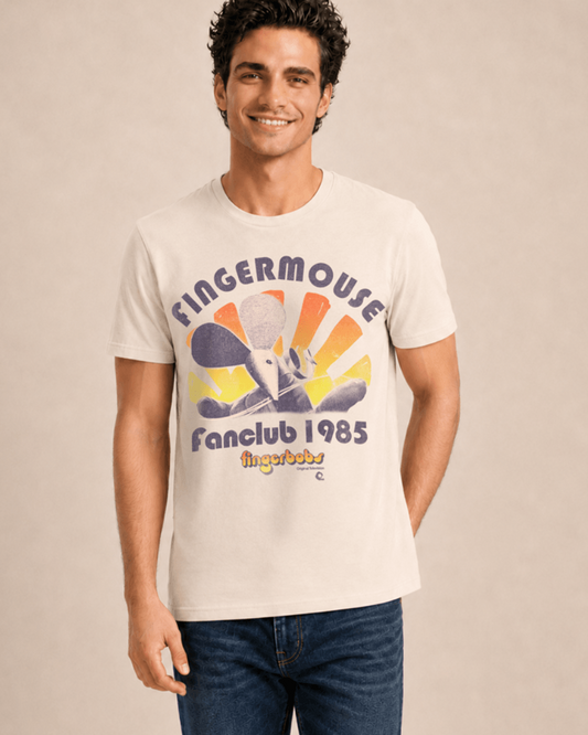 A man wearing a cream-colored graphic t-shirt with a retro design that reads 'FINGERMOUSE Fanclub 1985' and 'fingerbobs' at the bottom, paired with blue jeans, set against a plain beige background.