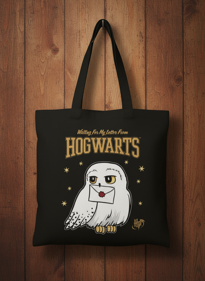 Harry Potter Black tote bag with a Hedwig owl holding an envelope and 'Hogwarts' text 
