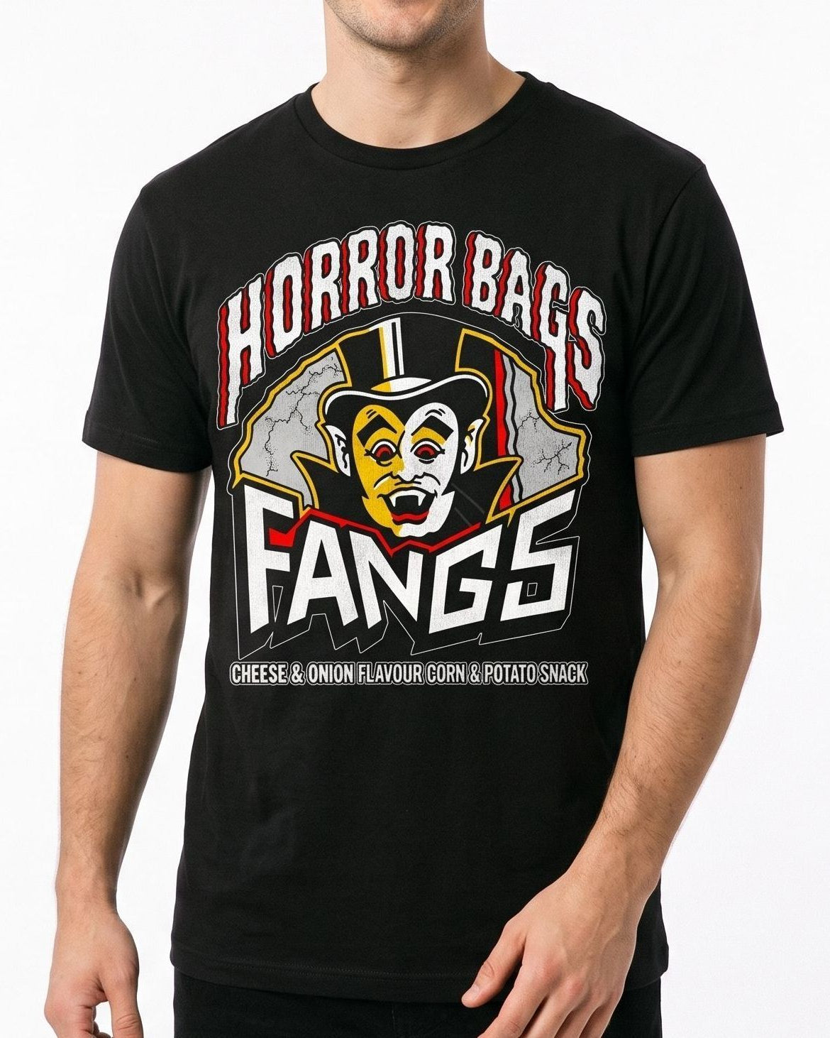 A man wearing a black graphic t-shirt with a vampire design and the text 'HORROR BAGS FANGS' and 'CHEESE & ONION FLAVOUR CORN & POTATO SNACK'.
