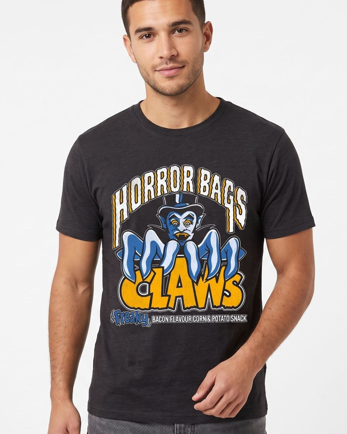 A man wearing a dark charcoal gray graphic t-shirt featuring a cartoon mascot and the text 'HORROR BAGS CLAWS' in yellow and blue, photographed against a clean white background.