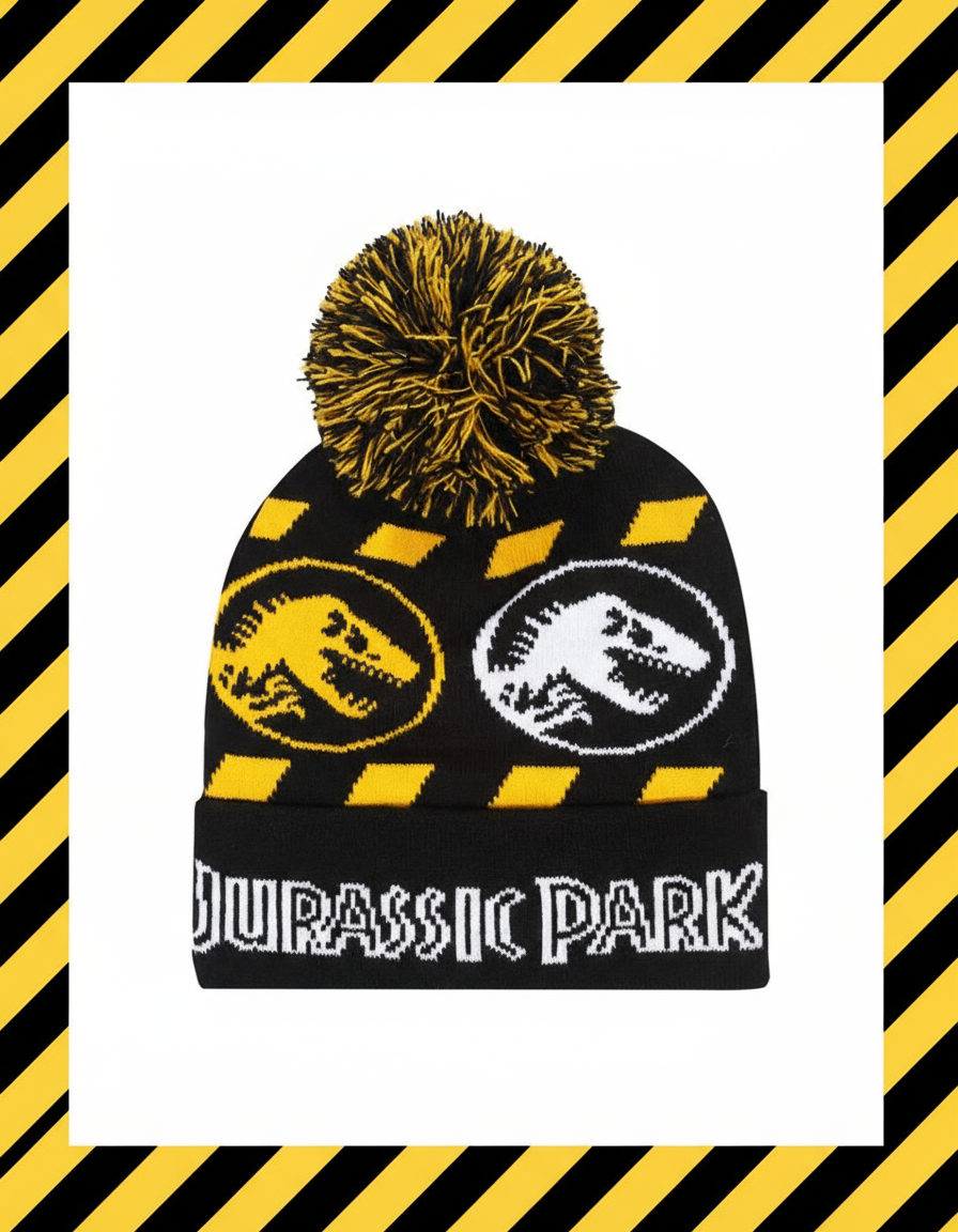 Black beanie with yellow and black pom-pom, dinosaur logos, and 'Jurassic Park' text 
