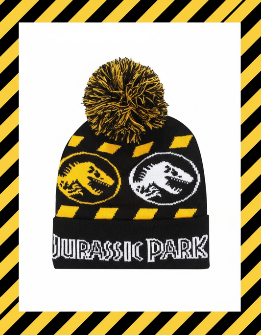 Black beanie with yellow and black pom-pom, dinosaur logos, and 'Jurassic Park' text 