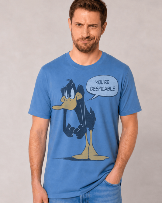 A man wearing a blue graphic t-shirt featuring a cartoon Daffy Duck with a speech bubble that says 'YOU'RE DESPICABLE'.