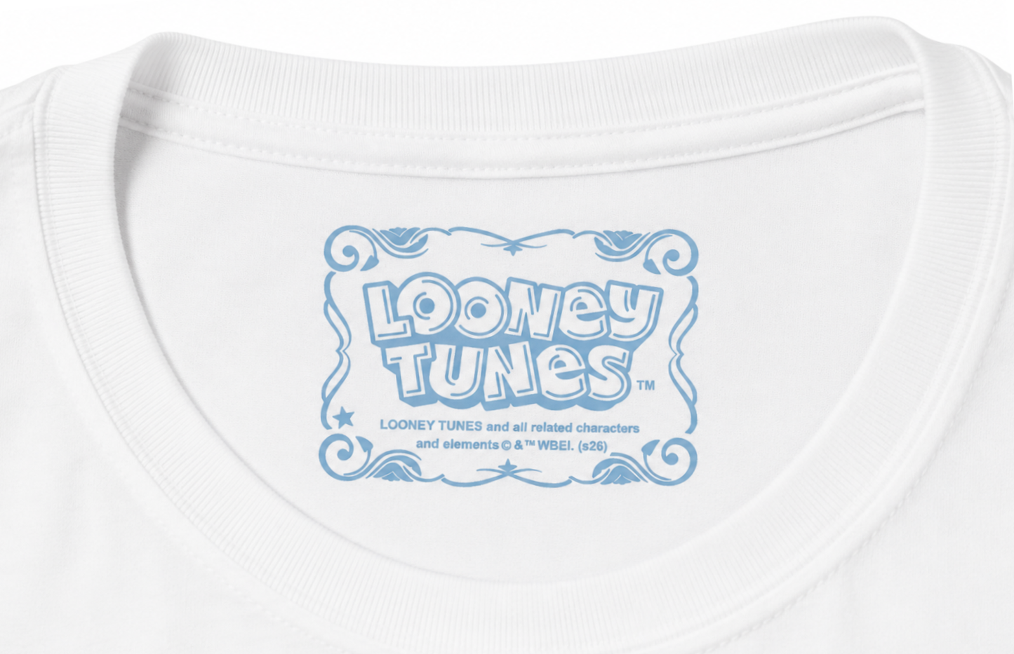 Close-up of a white crewneck t-shirt featuring a light blue graphic print on the inside collar that reads 'Looney Tunes' with trademark text below.