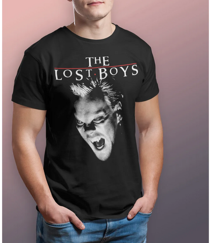 Man wearing Unisex short sleeve black t-shirt featuring official The Lost Boys 80s Vampire movie David design with The Lost Boys text / Retro Tees