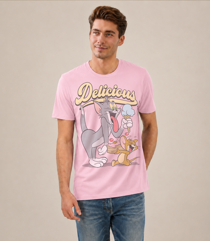 Man wearing an Official Tom and Jerry Pink t-shirt with cartoon Tom eating ice cream and Jerry eating cake and 'Delicious' text above 