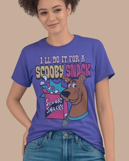 A woman wearing a dusk blue Scooby-Doo graphic t-shirt with the text 'I'LL DO IT FOR A SCOOPY SNACK' and an illustration of Scooby and a snack box, paired with blue jeans against a solid beige background.