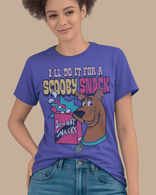 A woman wearing a dusk blue Scooby-Doo graphic t-shirt with the text 'I'LL DO IT FOR A SCOOPY SNACK' and an illustration of Scooby and a snack box, paired with blue jeans against a solid beige background.