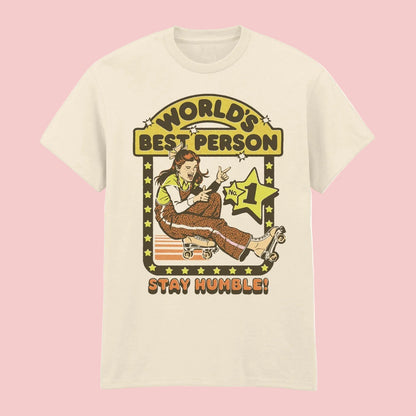 Steven Rhodes natural short sleeve t-shirt featuring a girl on roller skates with the text 'Worlds Best Person' 'Stay Humble'